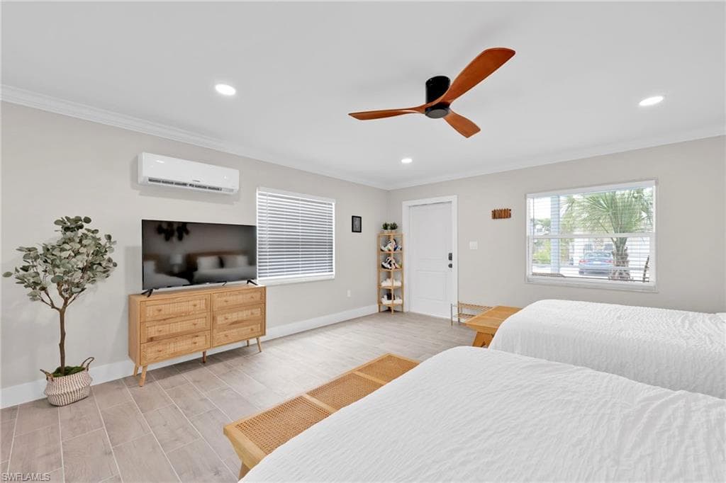 Bedroom with ceiling fan, crown molding, wood tiled floors, recessed lighting, and a wall mounted air conditioner