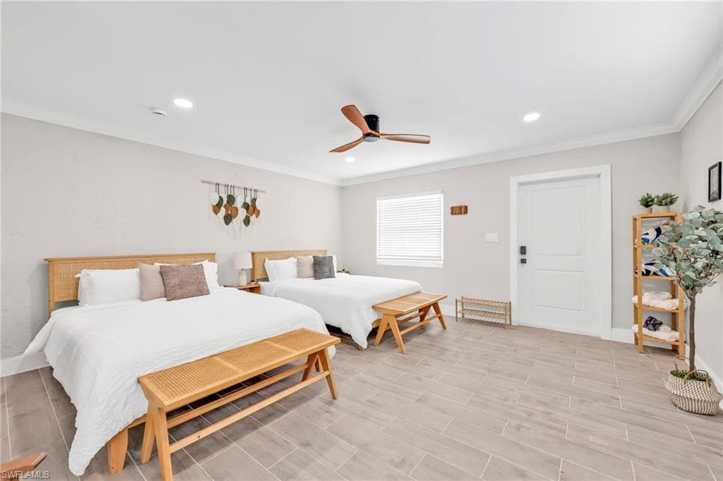 Bedroom with ornamental molding, a ceiling fan, recessed lighting, and wood finish floors