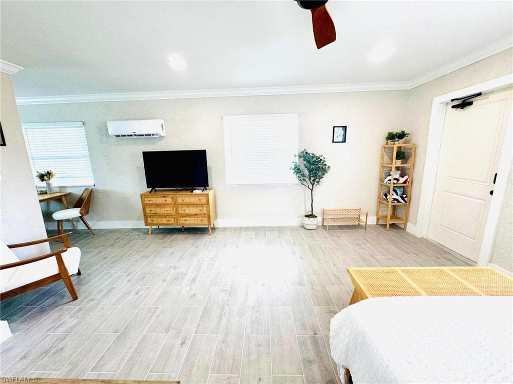 Bedroom featuring wood tiled floors, crown molding, ceiling fan, and recessed lighting