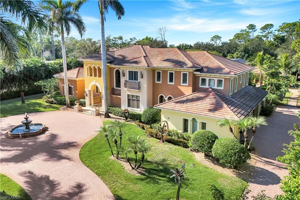 Mediterranean / spanish-style house featuring stucco siding, a tiled roof, and a front yard