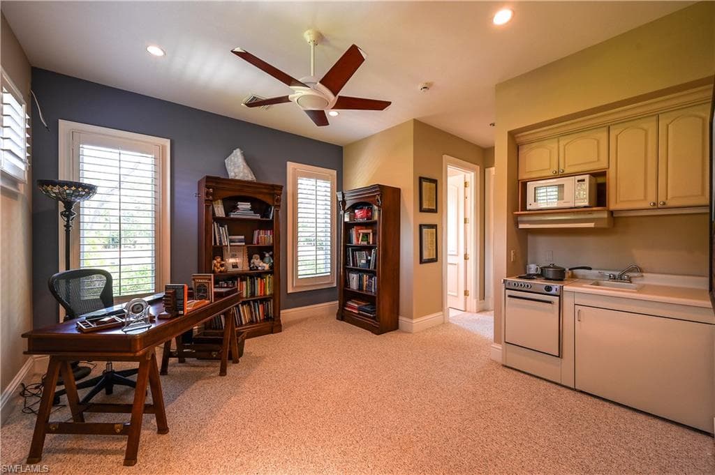 Guest apartment Office featuring ceiling fan, light colored carpet, and recessed lighting