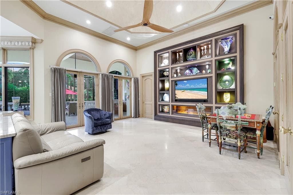 Living area featuring french doors, ceiling fan, crown molding, and recessed lighting