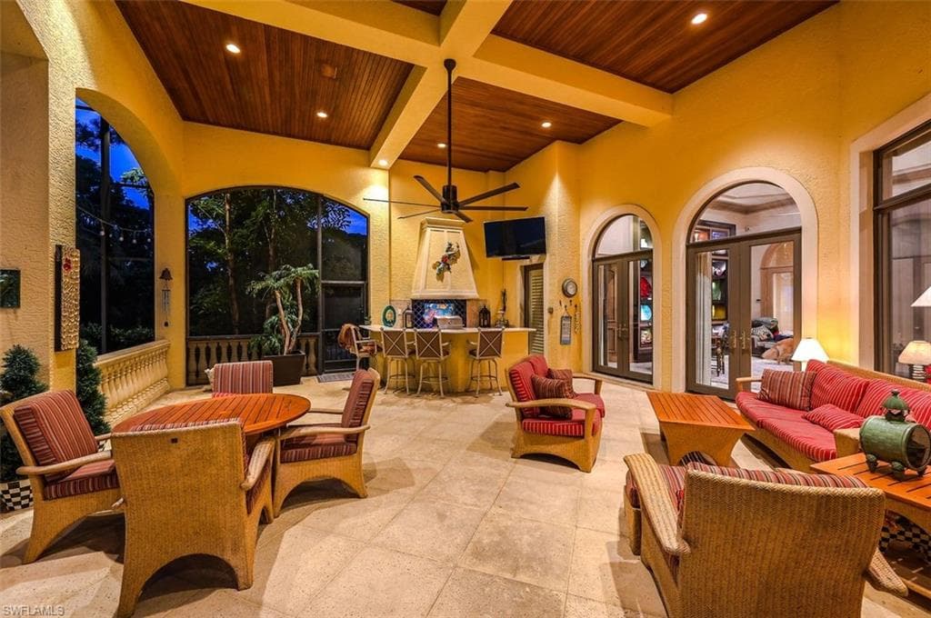 View of patio / terrace featuring a ceiling fan, french doors, an outdoor hangout area, and outdoor dining area