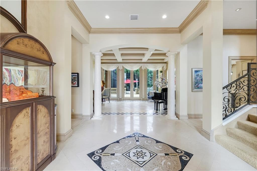Entry Hall with decorative columns, ornamental molding, stairs, french doors, and coffered ceiling