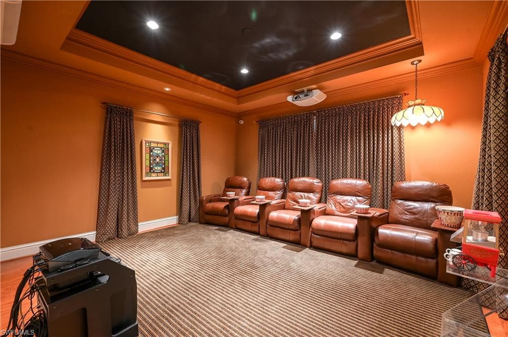Bedroom/ Current Cinema featuring ornamental molding, a raised ceiling, and recessed lighting