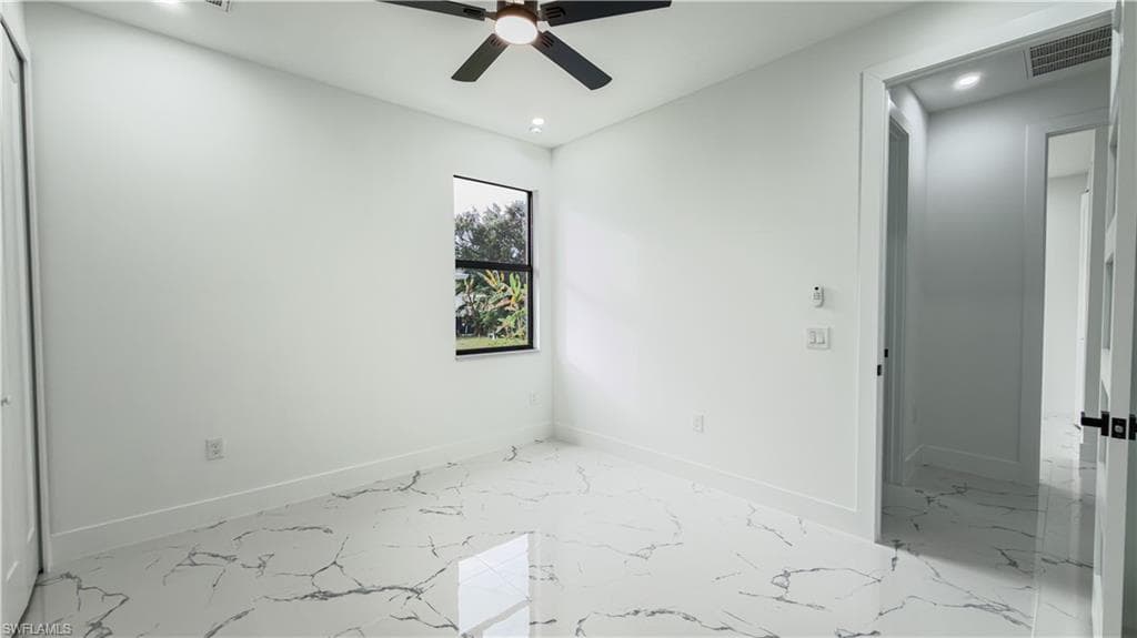 Unfurnished room with light marble finish floors, ceiling fan, and recessed lighting