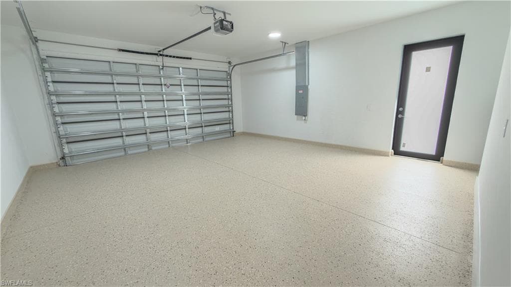 Garage with electric panel and a garage door opener