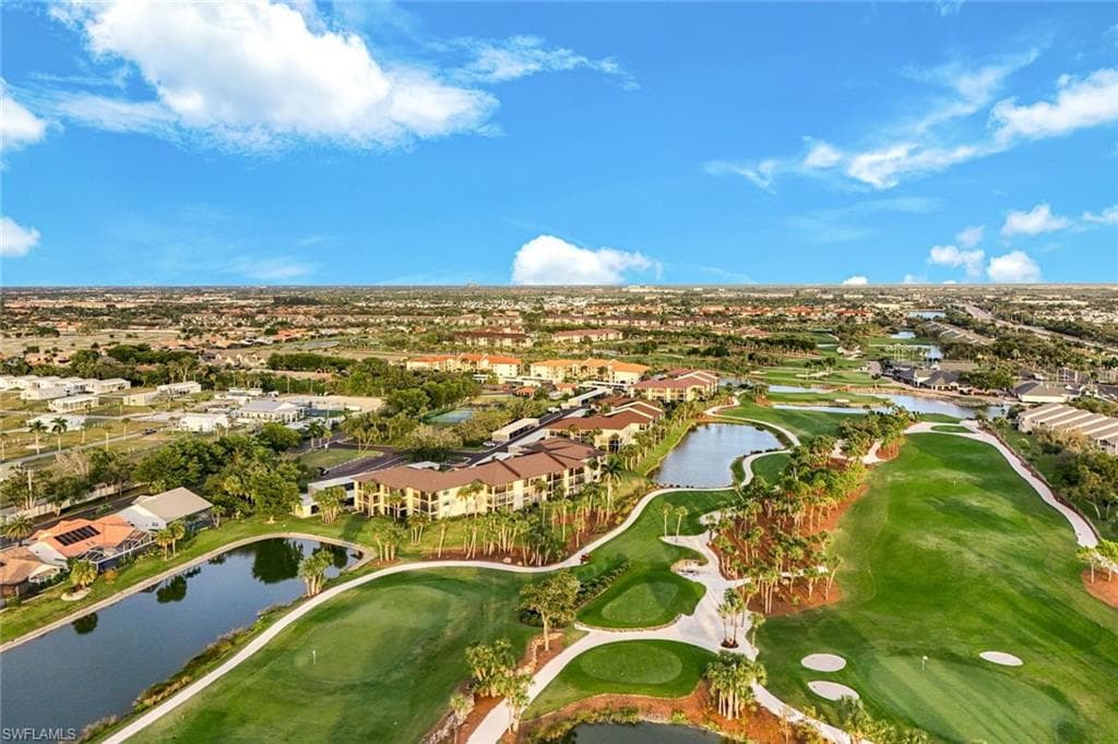 Aerial view of property's location with a nearby body of water, a golf club, and nearby suburban area