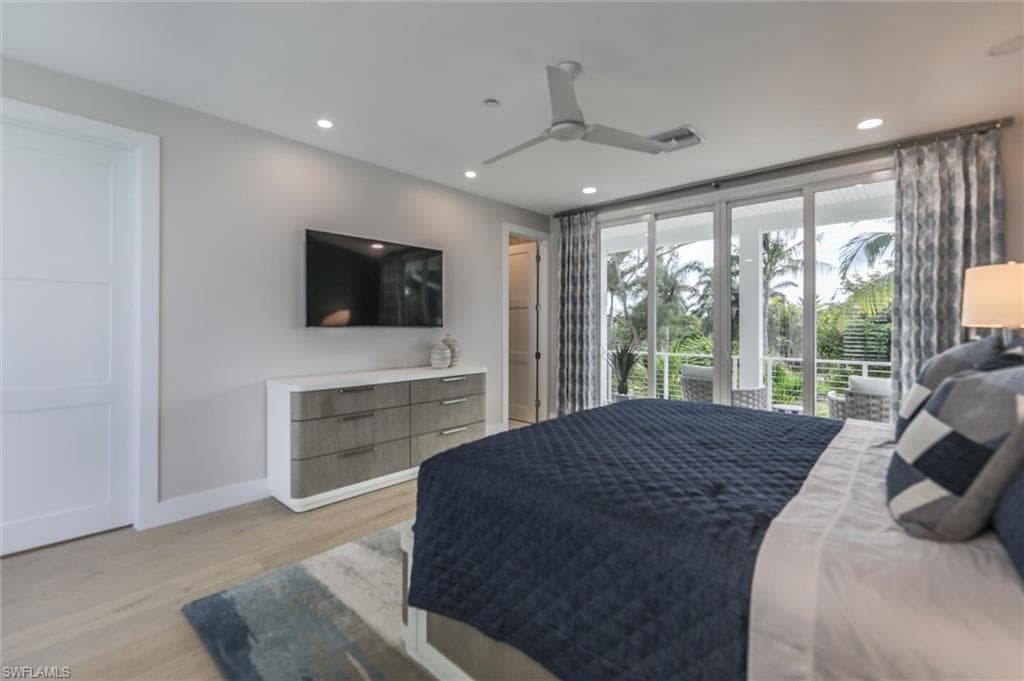 Bedroom with ceiling fan, light wood-type flooring, and access to outside