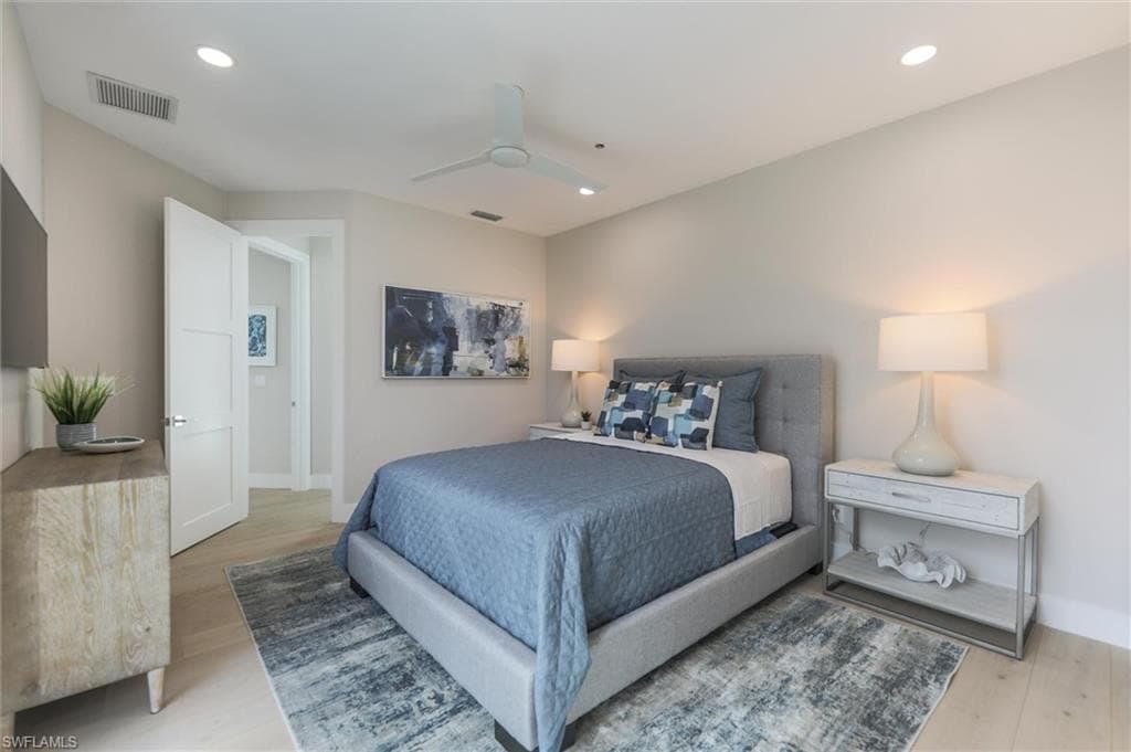 Bedroom with ceiling fan and light hardwood / wood-style floors