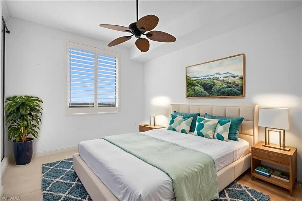 Carpeted bedroom with baseboards and a ceiling fan