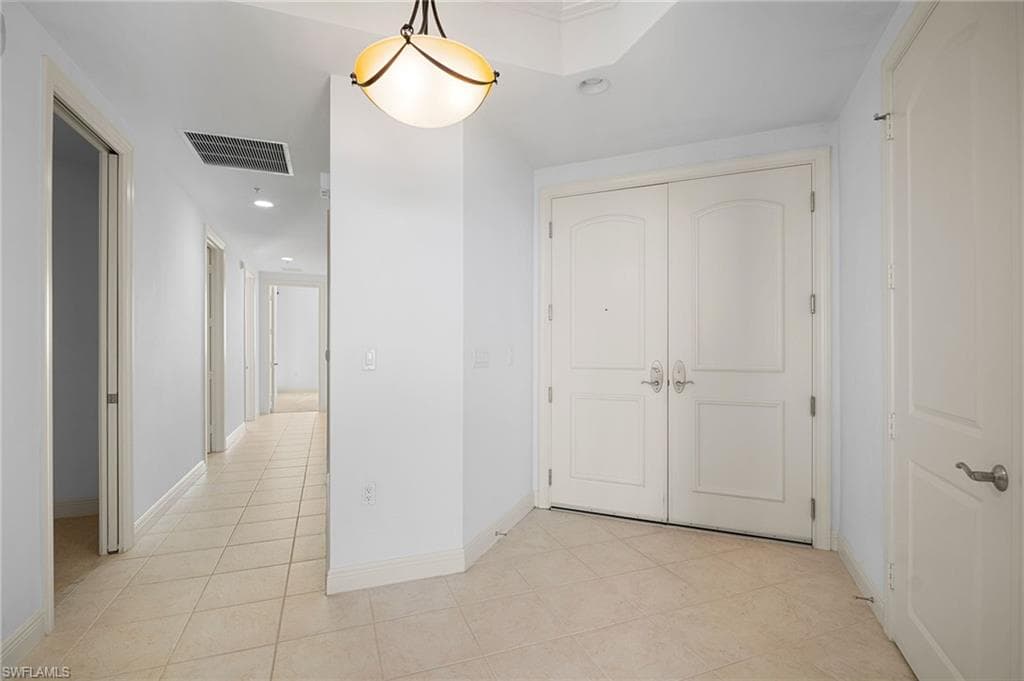 Hall featuring recessed lighting and light tile patterned floors