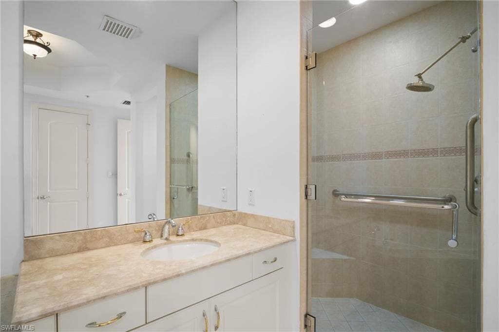 Full bath featuring vanity and a shower stall