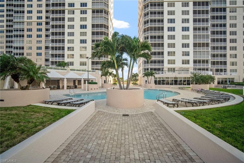 Community pool with a lawn and a patio