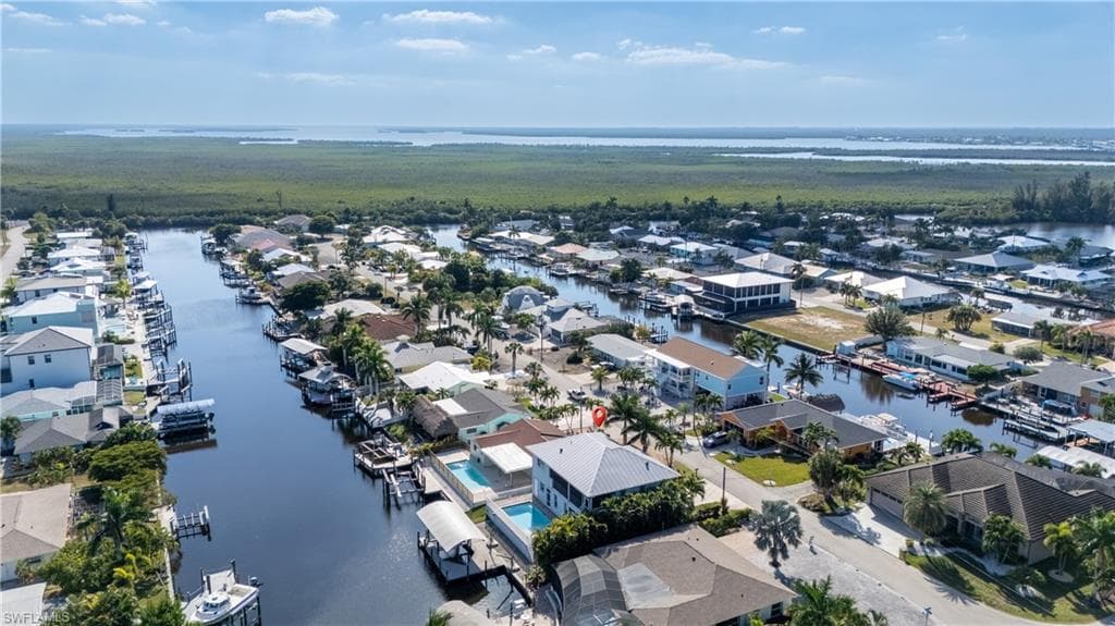 Aerial perspective of suburban area featuring a large body of water