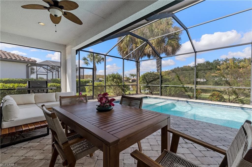 Sunroom / solarium featuring a ceiling fan, an outdoor living space, and a patio area