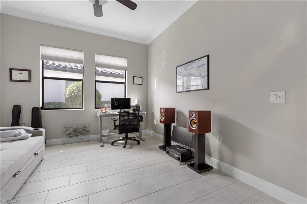 Office featuring crown molding, light tile patterned floors, and ceiling fan