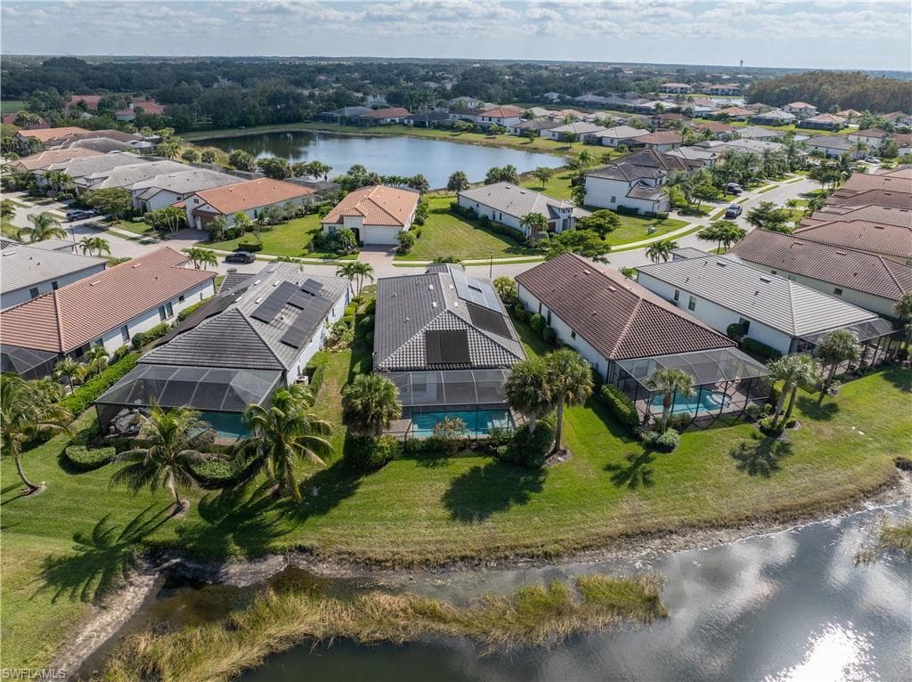 Aerial view of residential area featuring a nearby body of water