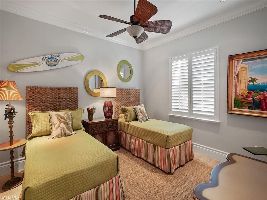 Bedroom featuring ornamental molding, a ceiling fan, and wood finished floors