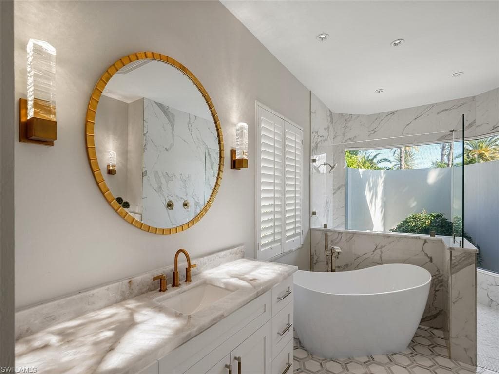 Bathroom featuring a freestanding tub and vanity