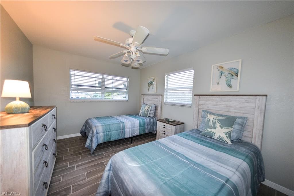 Third bedroom with coastal decor and porcelain tile floor
