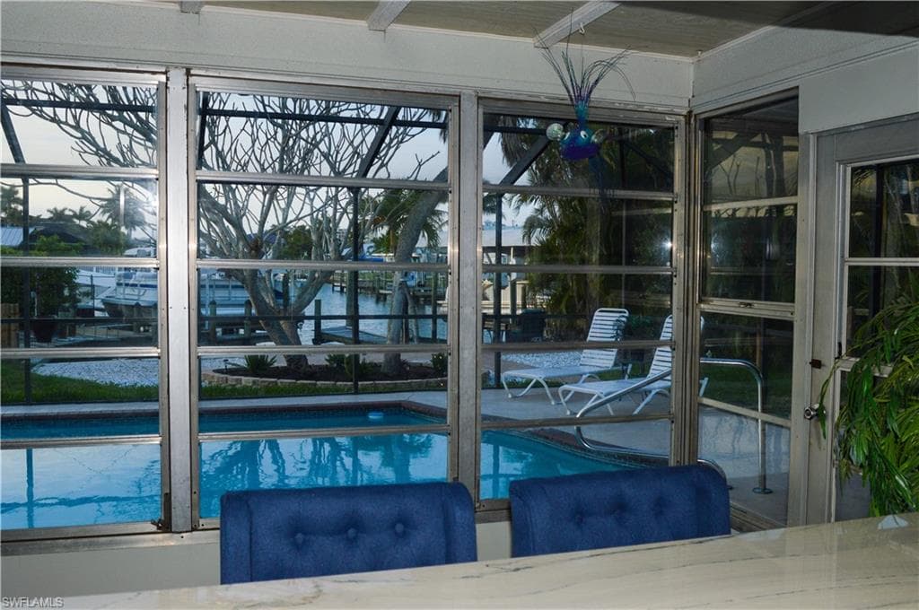 Breakfast bar with view of pool and waterfront canal