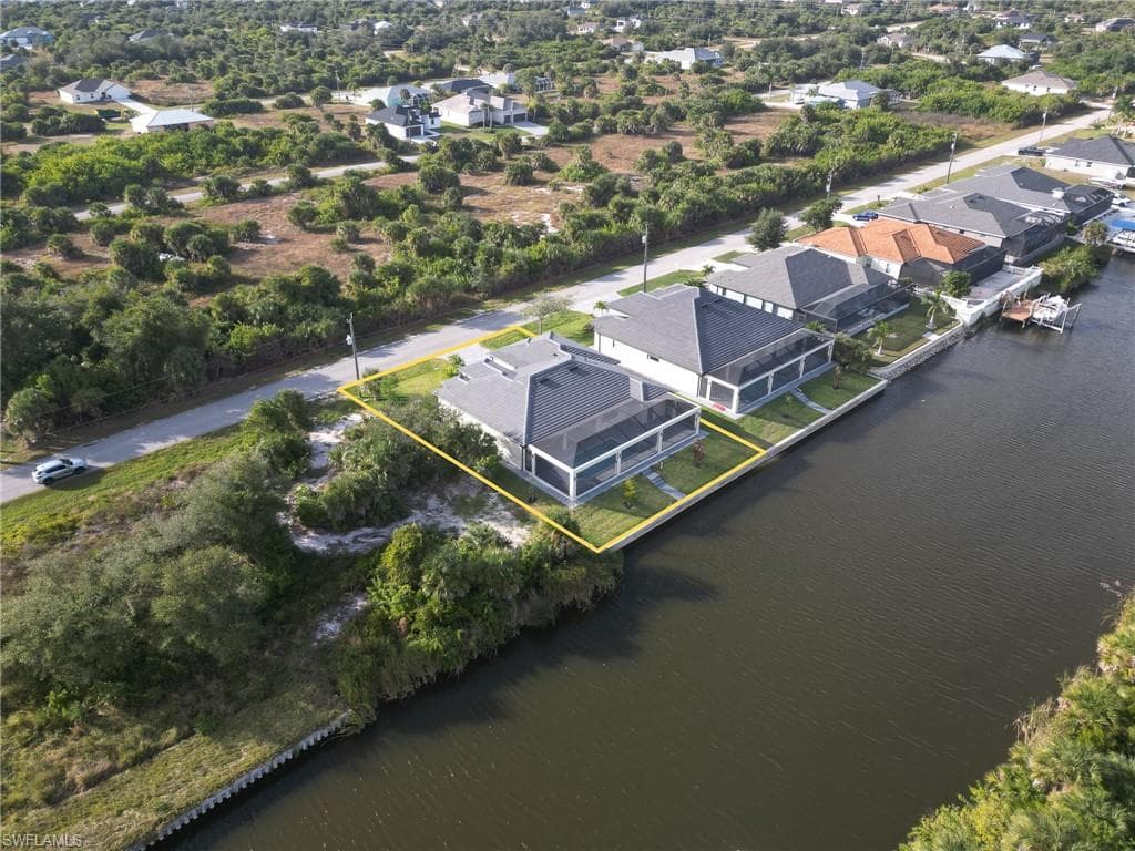 Aerial perspective of suburban area with a large body of water