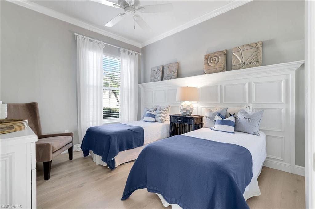 Bedroom with crown molding, light wood-type flooring, and ceiling fan