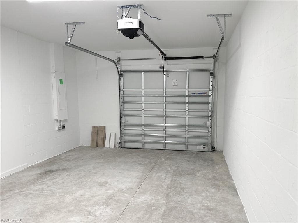 Garage with concrete block wall and a garage door opener
