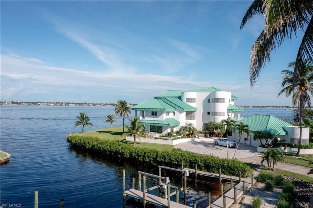 Water view with boat lift and a dock