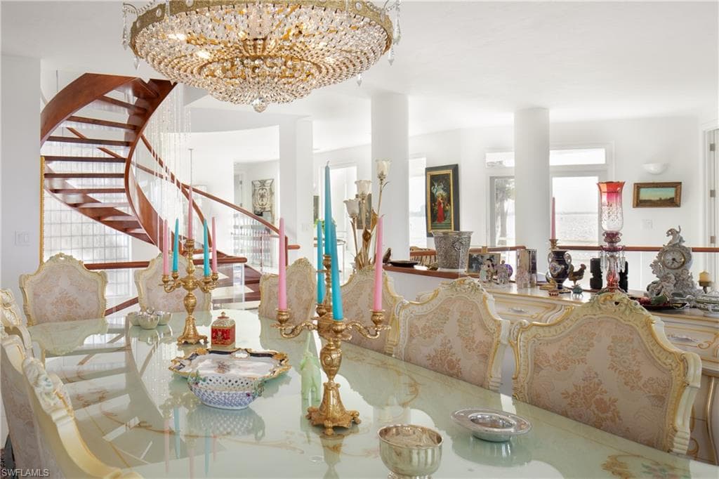 Dining space with stairway and a chandelier