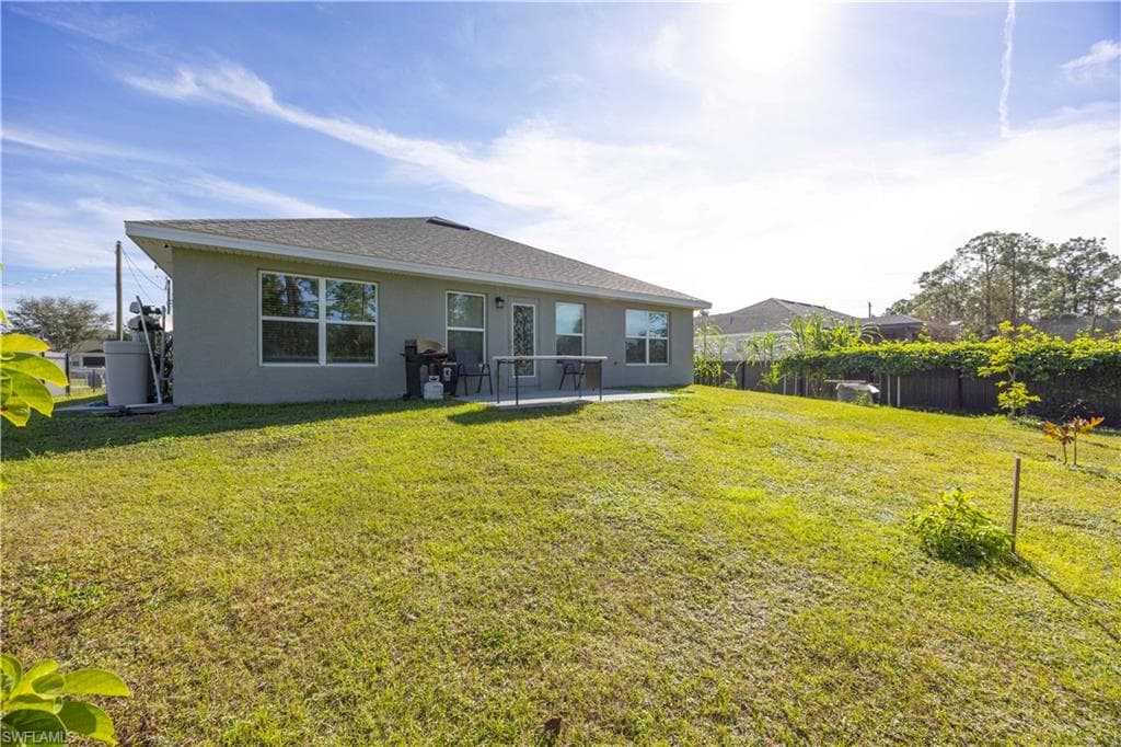 Rear view of property with stucco siding and a patio