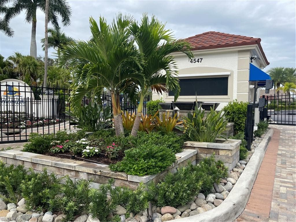 View of home's community with a gate