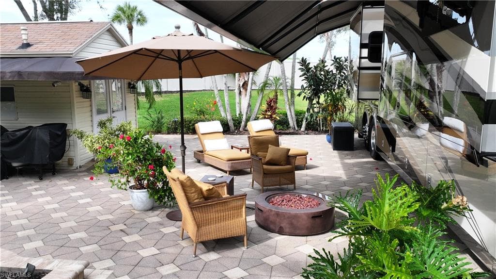View of patio featuring a fire pit and area for grilling