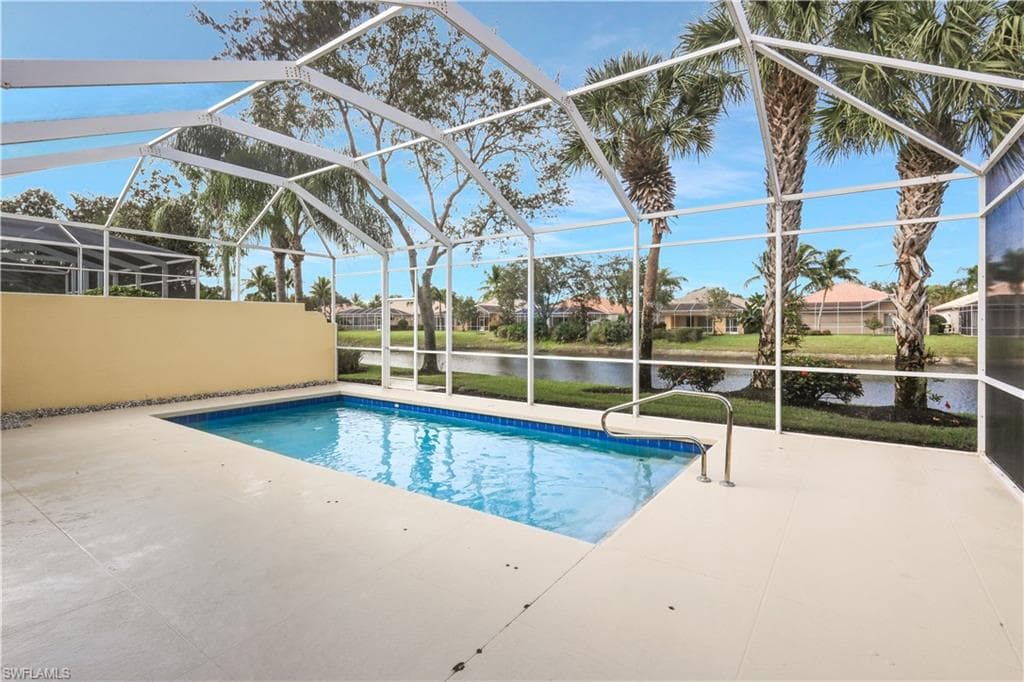 Outdoor pool with a water view, a sunroom, a patio, a lanai, and a residential view