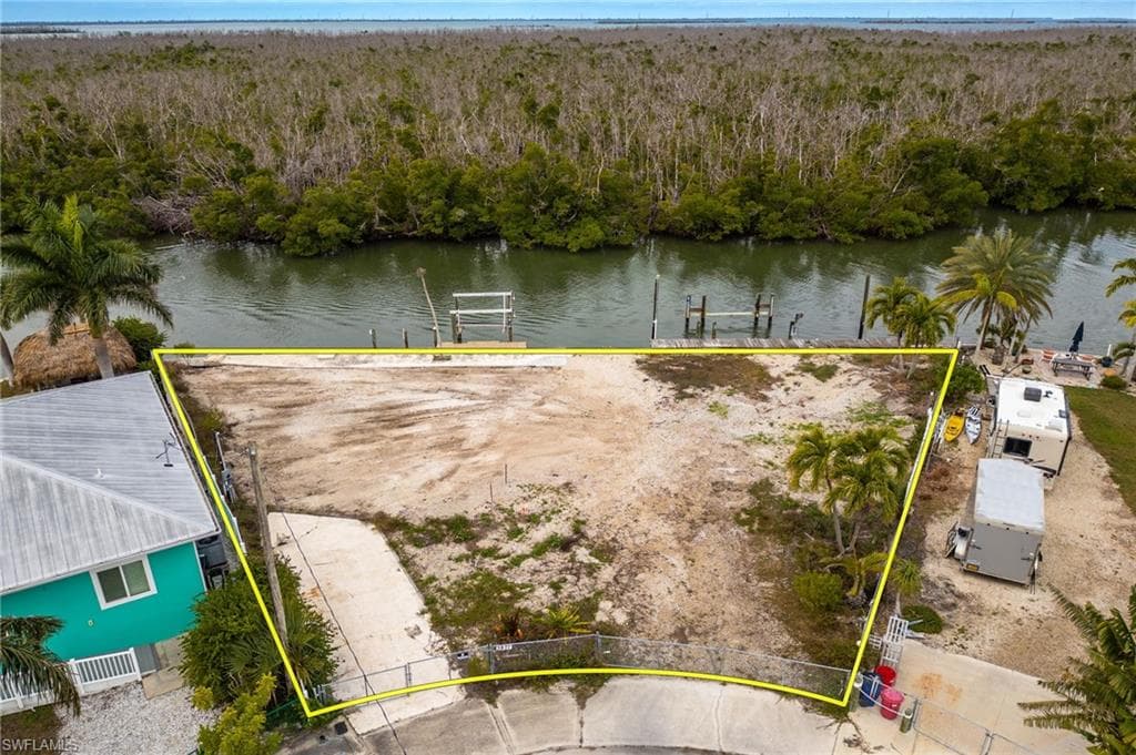 Aerial overview of property's location with a forest and property parcel outlined