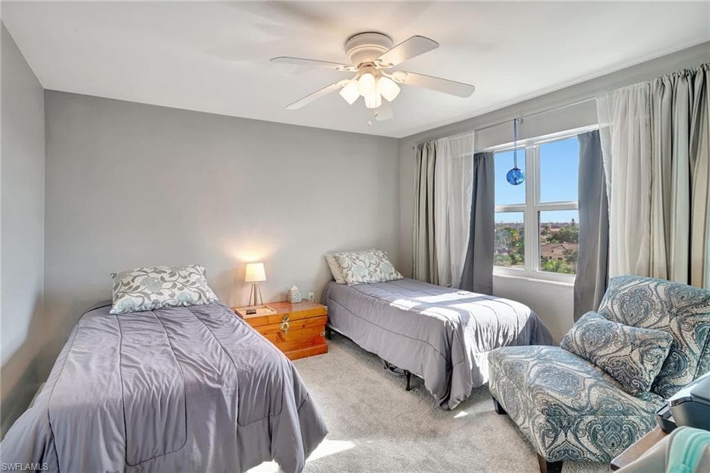 Guest Bedroom with carpet, ceiling fan and nice city view.