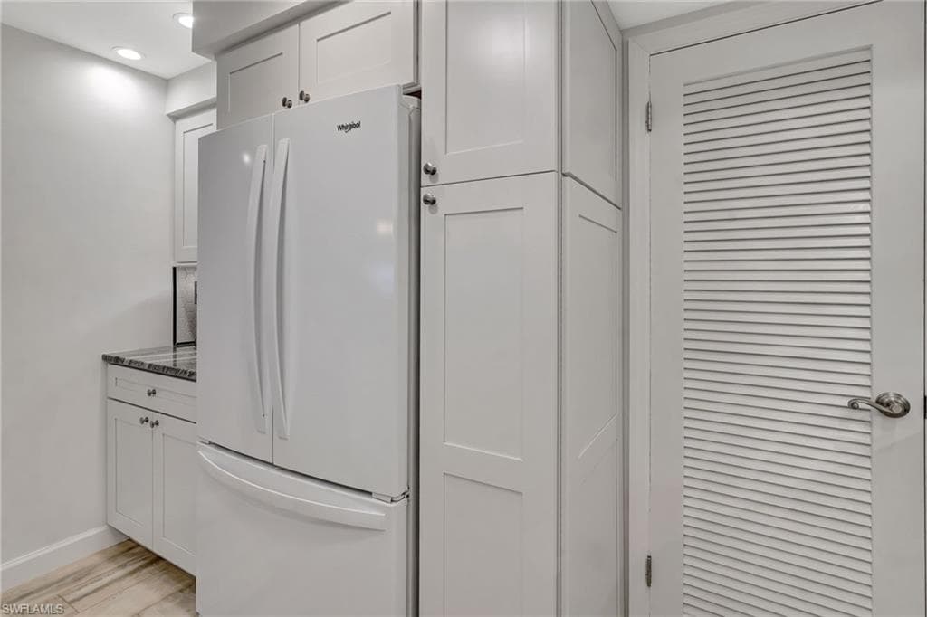 Kitchen featuring refrigerator w/ice maker, coffe bar and a pantry