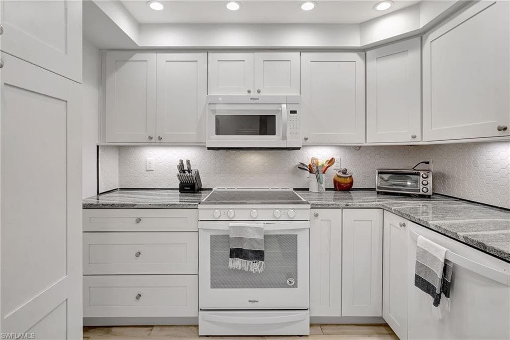 Kitchen featuring newer appliances, lazy susan in corner and recessed lighting