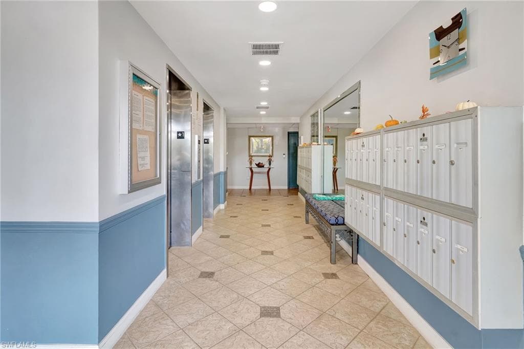 Lobby hallway with mail area, and elevator
