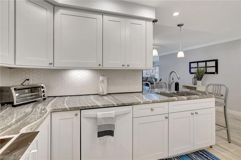 Kitchen featuring corner cabinet, lazy susan, and dishwasher.