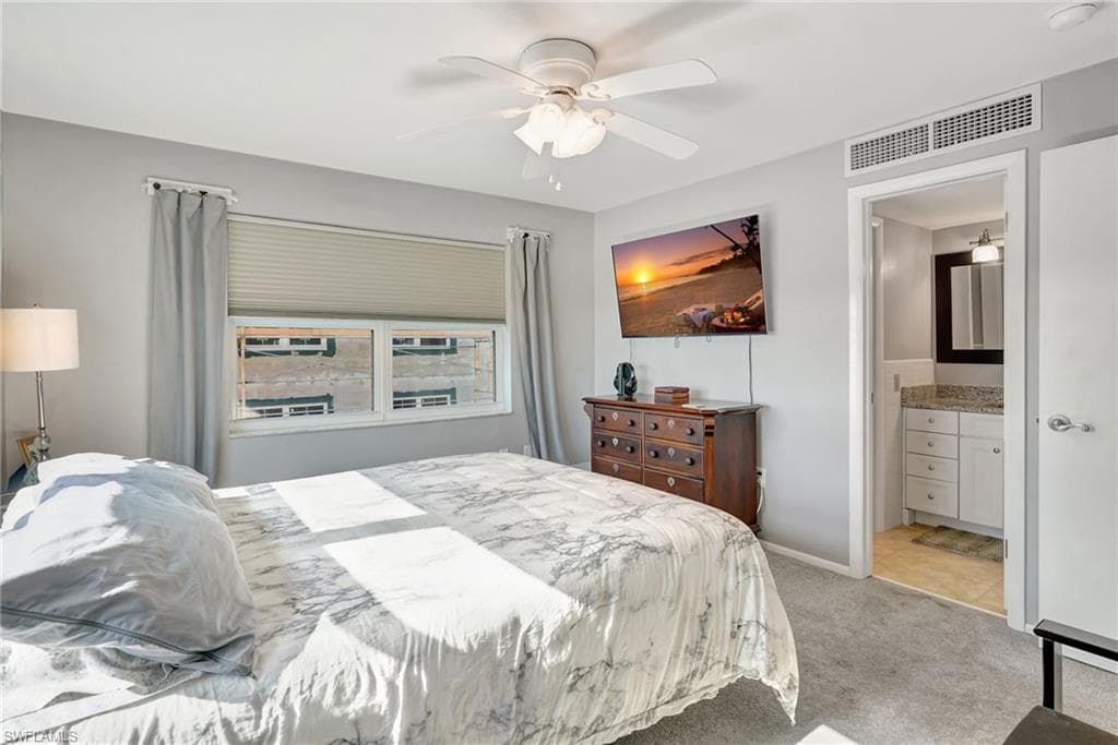 Master Bedroom featuring TV, ceiling fan, ensuite bath & walk-in closet