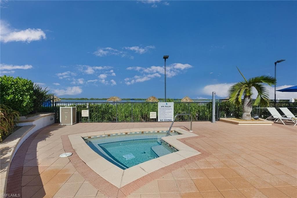 View of swimming pool with a community hot tub and a pool