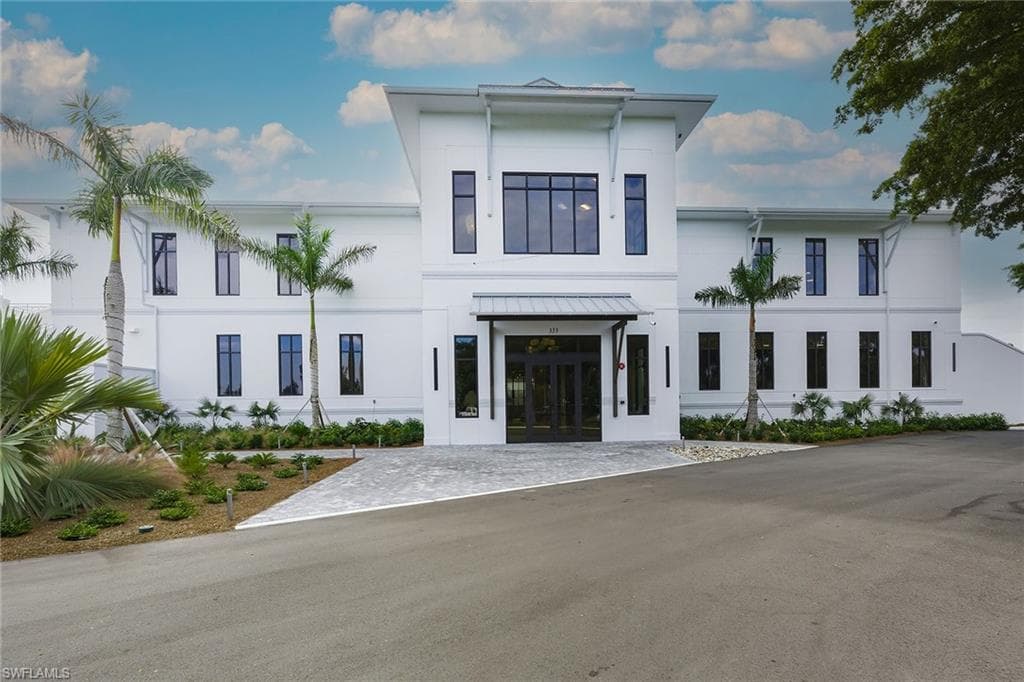View of front facade featuring french doors and stucco siding