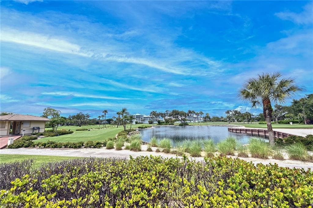 View of property's community with a water view and a yard