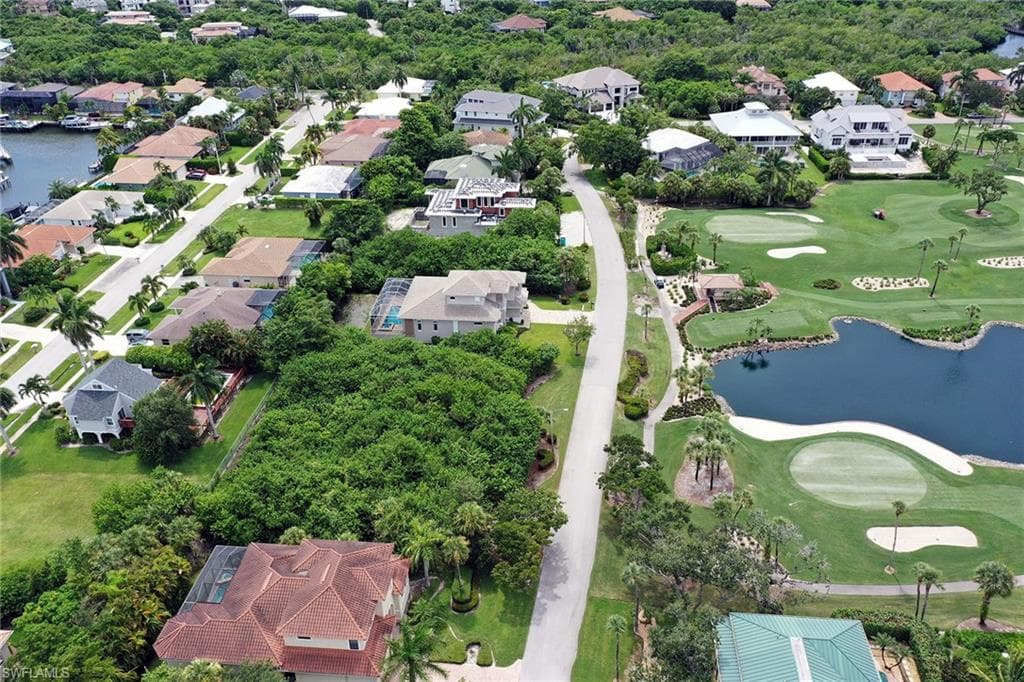 Aerial overview of property's location with a nearby body of water and nearby suburban area
