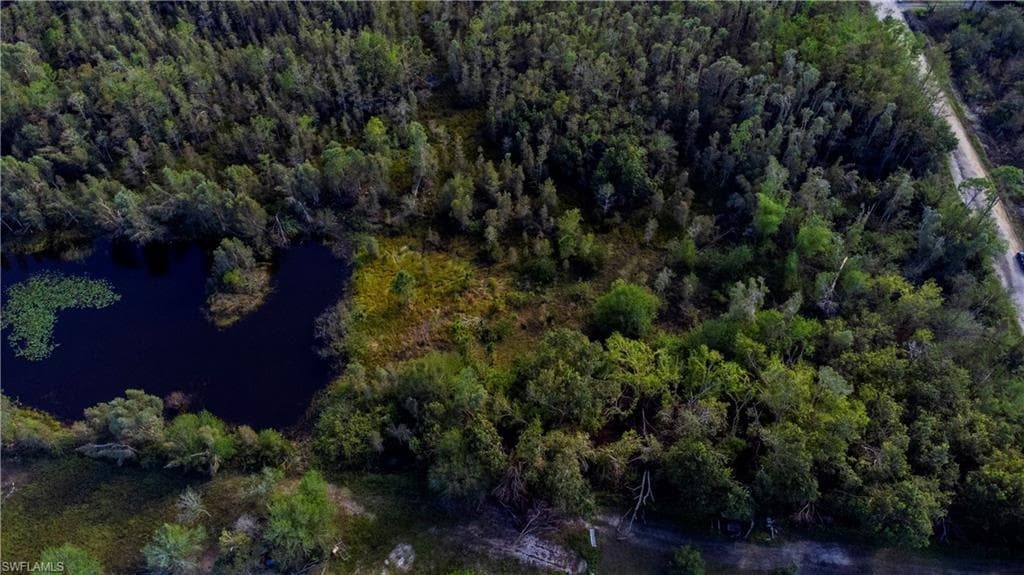 Aerial view of property's location with a large body of water