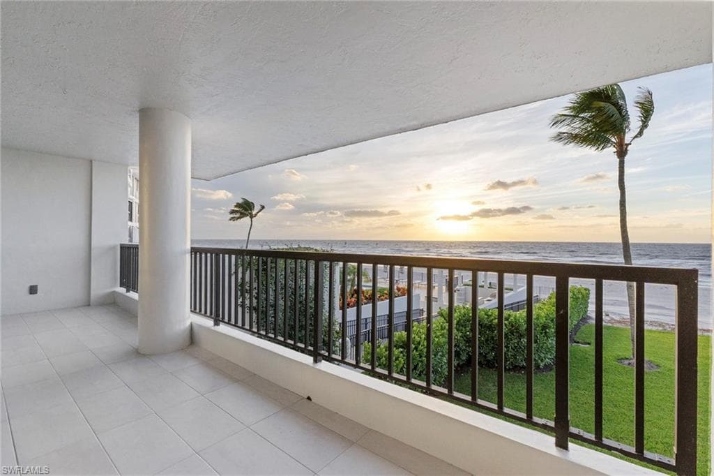 Balcony with view of water and beach