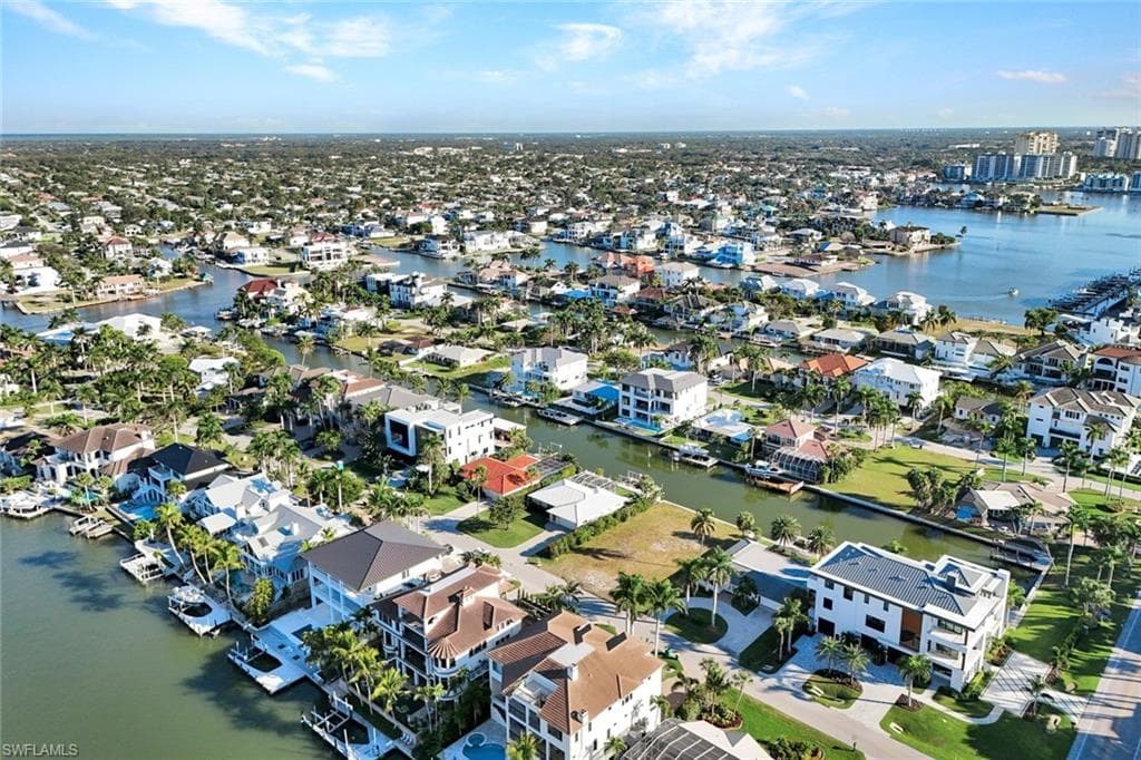 Aerial perspective of suburban area with a nearby body of water