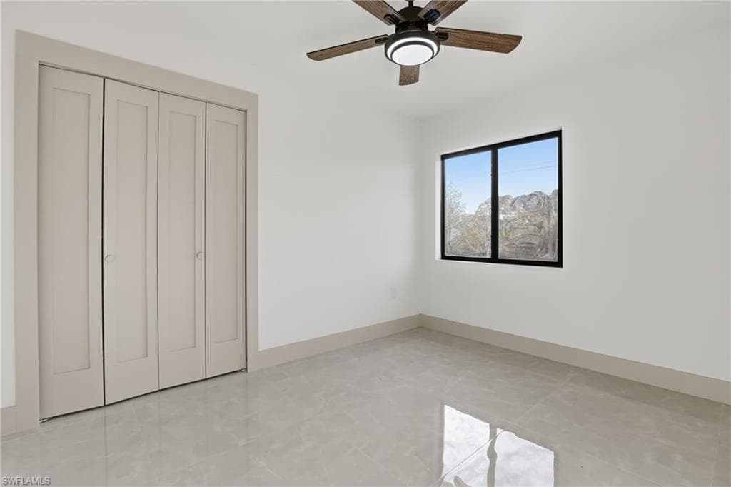Unfurnished bedroom with a closet and a ceiling fan